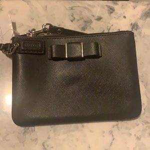 Black coach wristlet with a bow